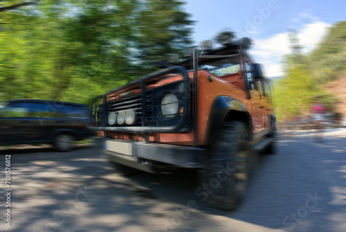An offroad jeep in motion blurred on a road, Sports utility vehicle for adventure