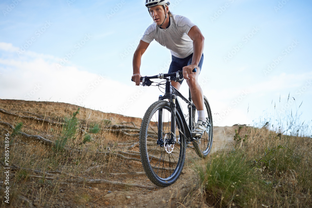 Man, cyclist and mountain bicycle for exercise, training and energy for rider, cycling and sport. Outdoor, hobby and fitness in nature, trail and active for wellness, helmet and physical workout