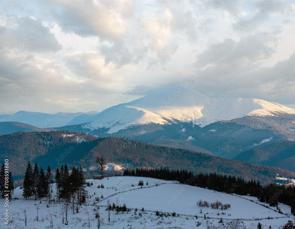 Evening winter cloudy day snow covered alp mountain ridge (Ukraine, Carpathian Mountains, Chornohora Range - Hoverla, Petros and other mounts, scenery view from Yablunytsia pass).