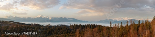 Canvas Print Spring dusk Carpathian mountains landscape with snow-covered ridges in far, Ukraine