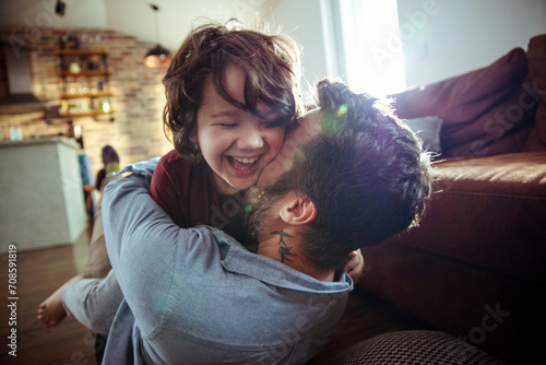 Father and son enjoying playtime and laughing at home photo