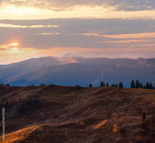 Picturesque dusk above late autumn mountain countryside. Ukraine, Carpathian Mountains. Peaceful traveling, seasonal, nature and countryside beauty concept scene.