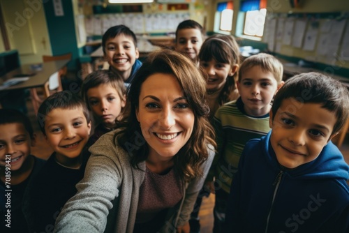 Smiling female teacher taking a selfie with her elementary students