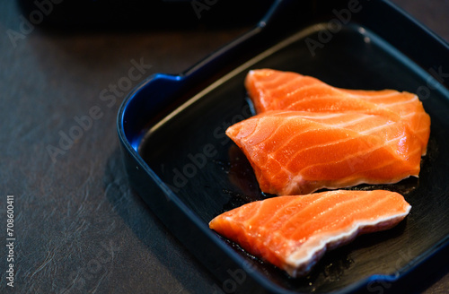 sliced salmon on black dish and black background. Japanese food