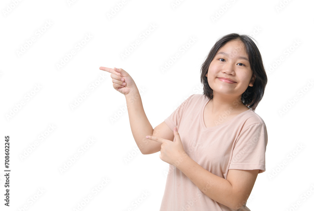 Asin teenager child pointing to the side with a finger to present a product or idea. Asin teenager child pointing to the side with a finger to present a product or idea.