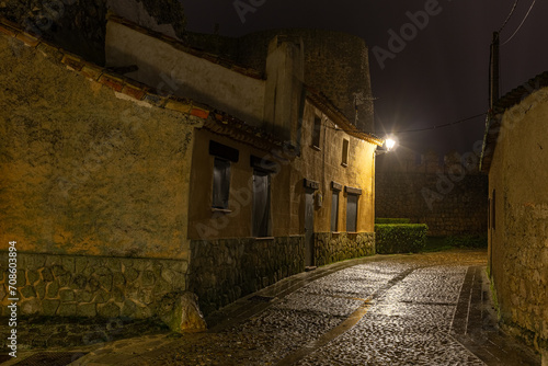 Cobblestone street, houses and wall in the town of Urueña at night. Valladolid, Castilla y León, Spain.