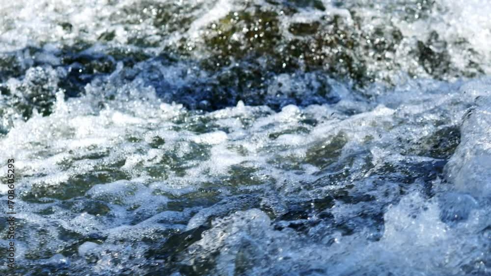 Strong water flow in the river, a clear bubbling stream, rapids on a stone, clear cloudless weather. Strong water flow in the river, a clear bubbling stream, rapids on a stone, clear cloudless weather.