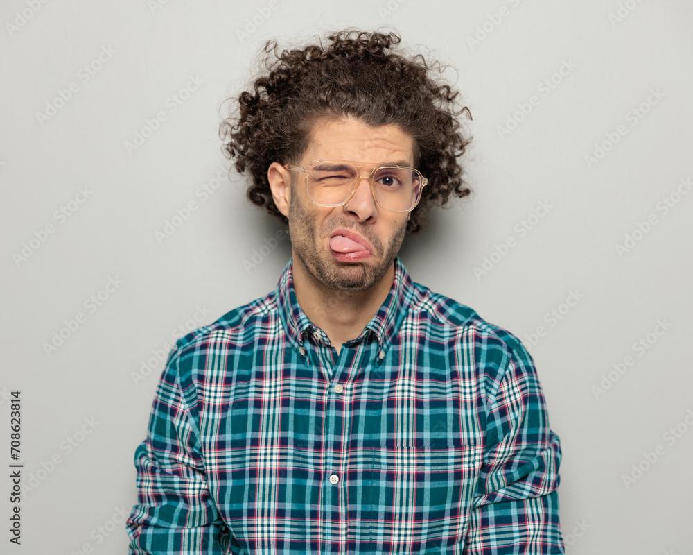 funny casual guy with curly hair and glasses making faces funny casual guy with curly hair and glasses making faces