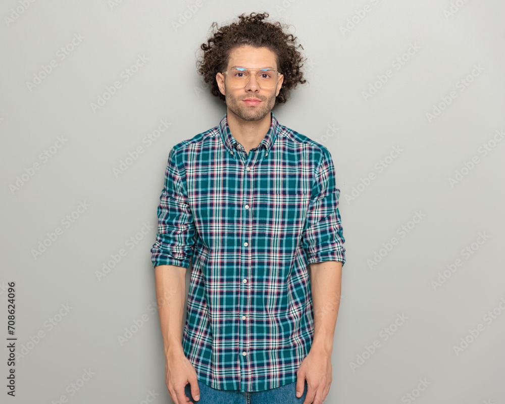 portrait of handsome casual man with glasses and plaid shirt looking forward portrait of handsome casual man with glasses and plaid shirt looking forward