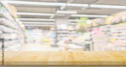 Empty wood table top with supermarket blurred background for product display © Kwangmoozaa