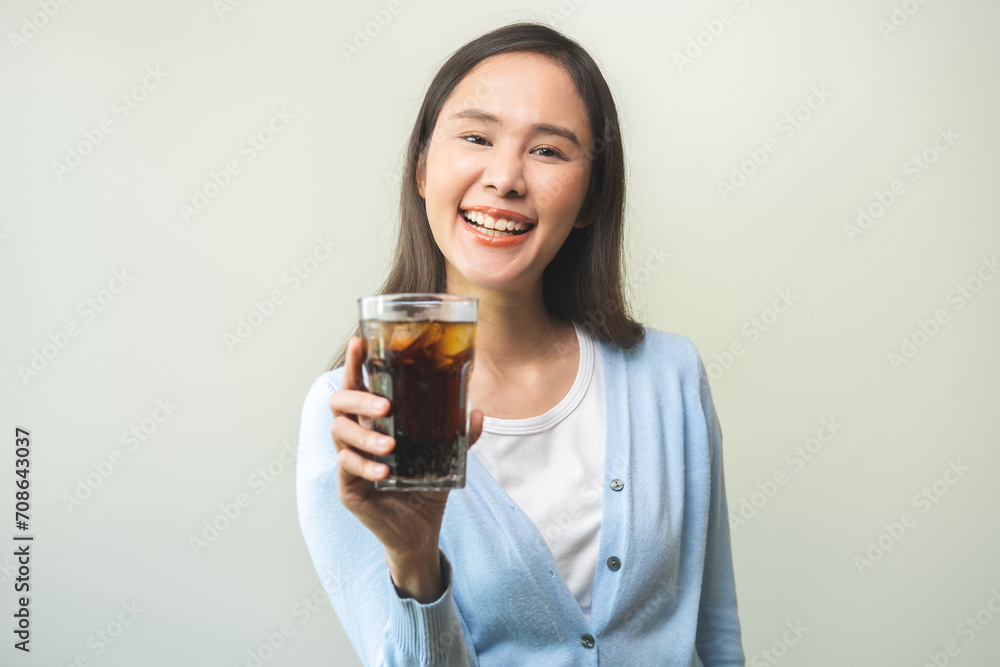 Thirsty, attractive asian young woman, happy girl drink or sip, holding a glass of cold sparkling water with ice in hand, refreshness people, isolated on background. Temptation of food, health care. Thirsty, attractive asian young woman, happy girl drink or sip, holding a glass of cold sparkling water with ice in hand, refreshness people, isolated on background. Temptation of food, health care.