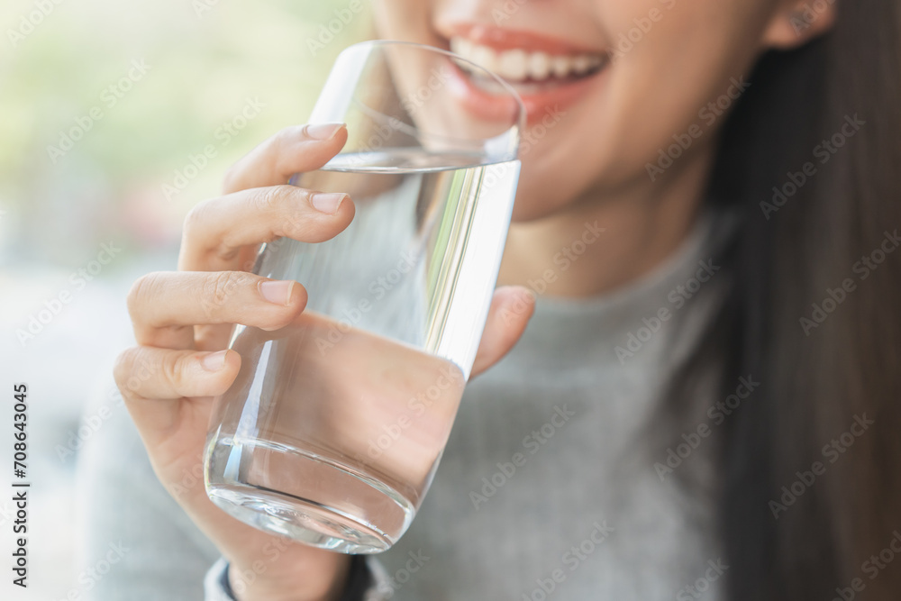 Happy beautiful, asian young woman, girl drinking, sip fresh glass of water for hydration of body, holding transparent glass in her hand, thirsty at home. Health care, healthy lifestyle concept. Happy beautiful, asian young woman, girl drinking, sip fresh glass of water for hydration of body, holding transparent glass in her hand, thirsty at home. Health care, healthy lifestyle concept.