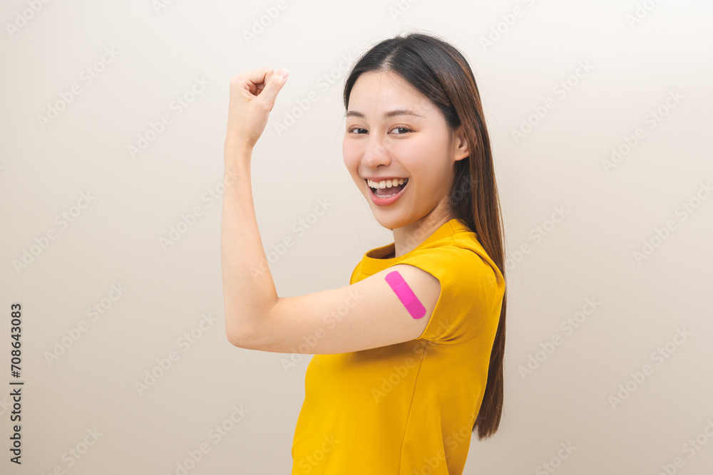 Healthcare of corona virus vaccination, happy asian young woman hand gesture showing strong with bandage, plaster on arm, getting vaccine immunity, giving injection influenza to protection pandemic. Healthcare of corona virus vaccination, happy asian young woman hand gesture showing strong with bandage, plaster on arm, getting vaccine immunity, giving injection influenza to protection pandemic.