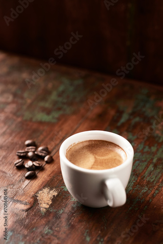  Cup of coffee on wooden background. Close up.