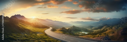 A curvy road winds through the mountains in sunset photo