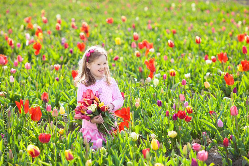 Little girl in tulip flower garden Little girl in tulip flower garden