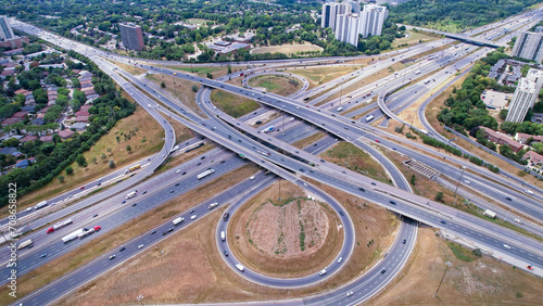 Highway aerial view. Speed ramps, expressway lanes roads and bridges. Aerial view of multilevel road junction with high speed moving cars. Road highway intersection interchange.