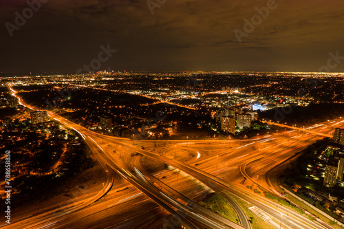 Top view deep night city of car traffic at intersection lane and buildings. Long exposure of urban cityscape. Modern city life in Canada  moving cars  trucks and buses.