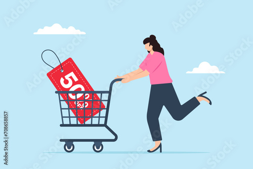 Young woman with shopping cart trolley and 50% discount price tag