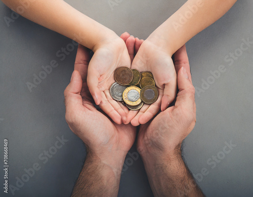 person holding a handful of coins