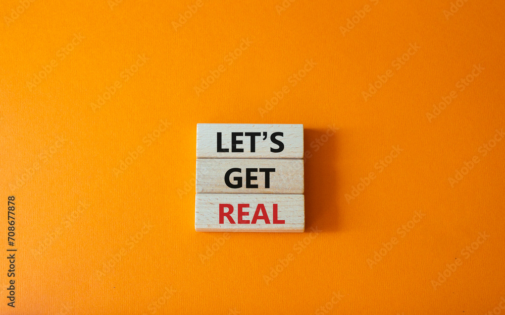 Lets get real symbol. Concept words Lets get real on wooden blocks. Beautiful orange background. Business and Lets get real concept. Copy space.
