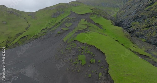 Aerial: Drone Ascending Panning Beautiful Shot Of Tranquil Mountains Against Cloudy Sky - Saksun, Faroe Islands photo