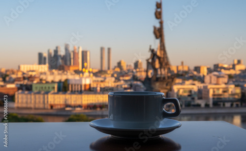 A cup of coffee on a table in a summer cafe with a panoramic view of the center of the Russian capital