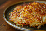 Swiss Rösti: Crispy Golden Potato Pancake on a Ceramic Plate, a Traditional Swiss Dish Ideal for Food Enthusiasts and Culinary Bloggers