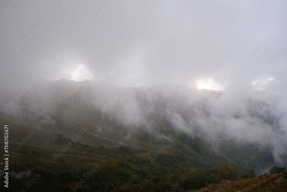Mountain peak in fog, fog shrouded a mountain peak, natural landscape