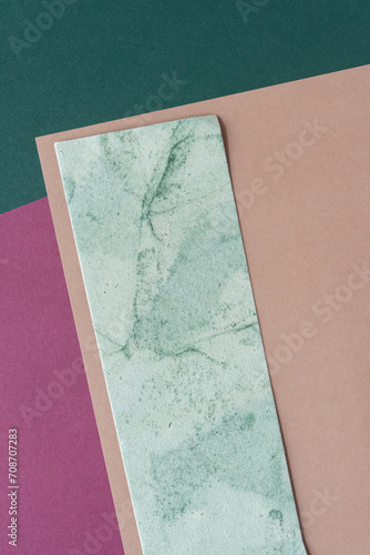 paper rectangle with marbled effect on beige, pink, and green paper