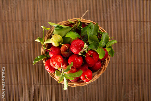 Freshly Harvested Organic Acerolas in a Basket on a Wooden Textured Table