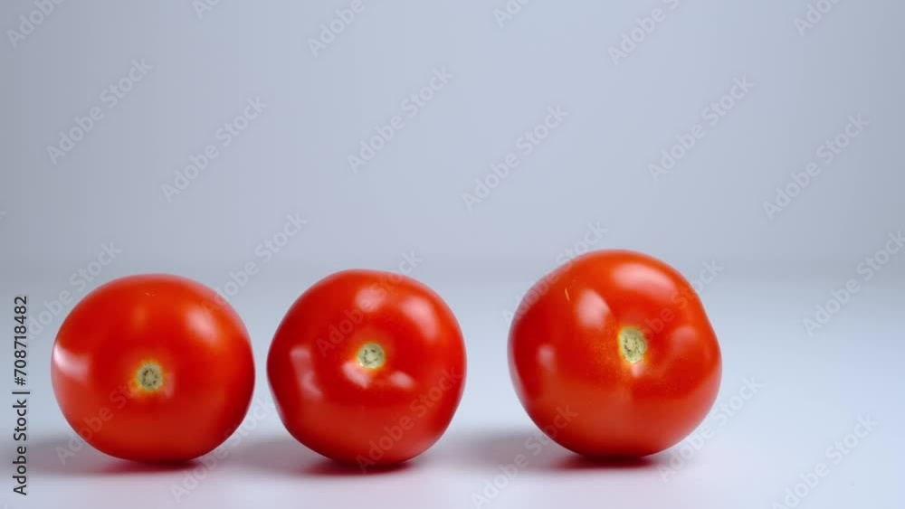 tomatoes lie in a row on a white background close-up tomatoes lie in a row on a white background close-up