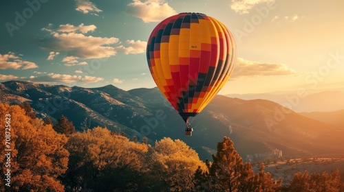  a hot air balloon flying in the sky over a mountain range with trees in the foreground and a mountain range in the background with trees in the foreground.
