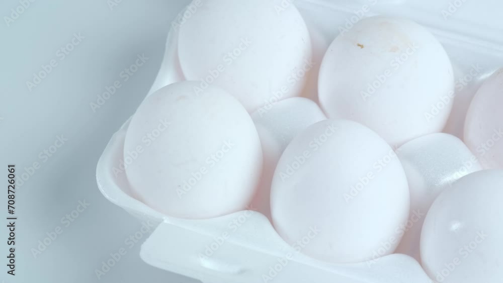 White chicken eggs in a tray close-up on a white background White chicken eggs in a tray close-up on a white background