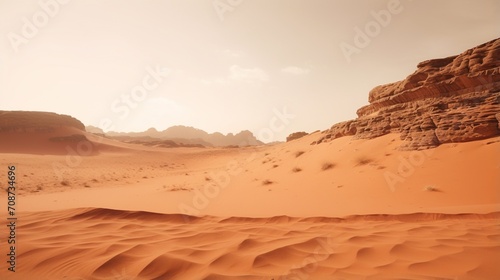 A vast desert landscape with red sand dunes and rocky mountains in the background