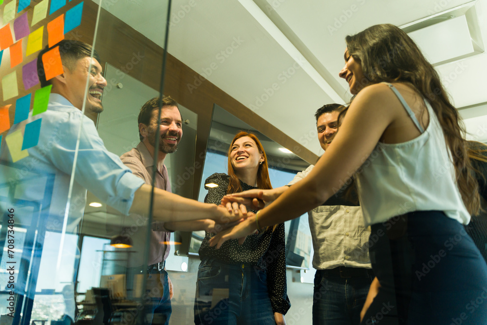 Obraz premium Happy and diverse group of businesspeople having fun together and working as a team