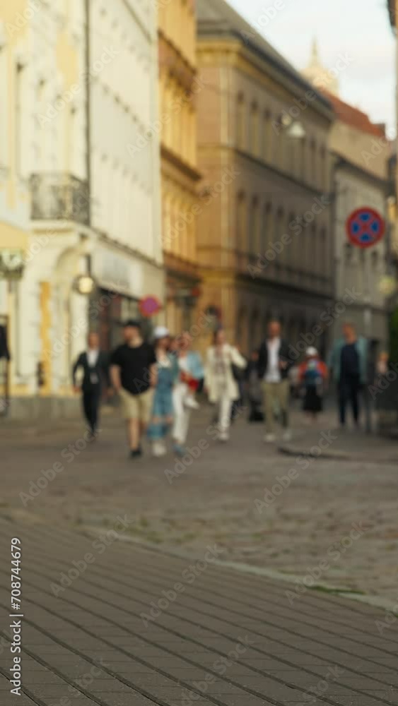 Establishing defocused shot capturing the summer city streets in vertical video Establishing defocused shot capturing the summer city streets in vertical video
