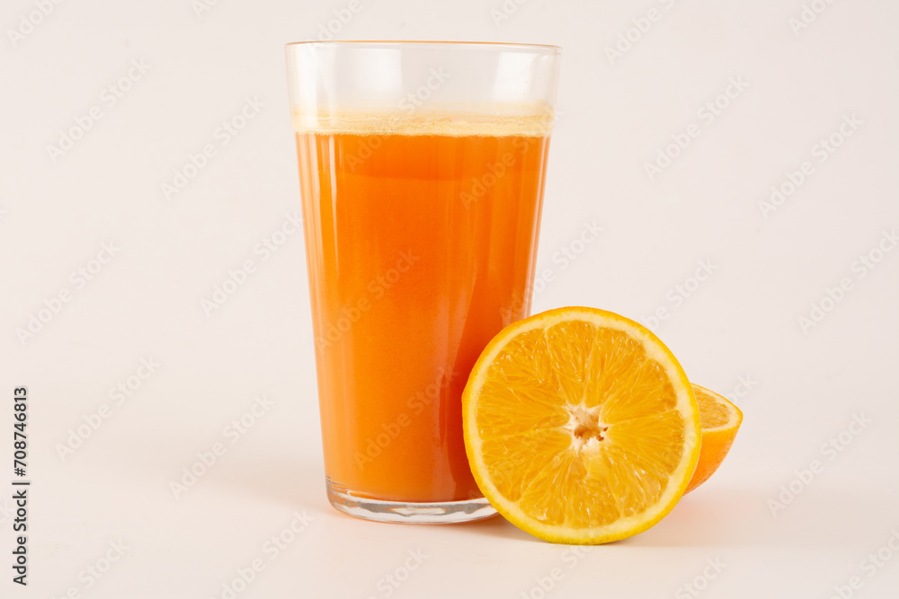 Fresh Organic Acerola and Orange Juice with sliced acerola and orange fruit in a glass cup in white background in top view Fresh Organic Acerola and Orange Juice with sliced acerola and orange fruit in a glass cup in white background in top view