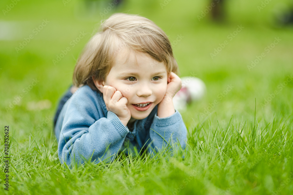 Cute toddler boy playing in blooming cherry tree garden on beautiful spring day. Adorable baby having fun outdoors. Cute toddler boy playing in blooming cherry tree garden on beautiful spring day. Adorable baby having fun outdoors.