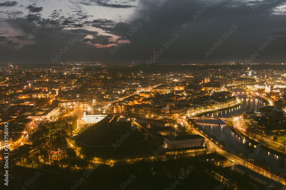 Scenic aerial view of Vilnius Old Town and Neris river at nightfall. Night view of Vilnius, Lithuania.