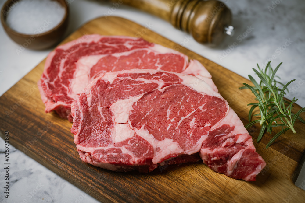 raw ribeye steak beef on white marble background raw ribeye steak beef on white marble background