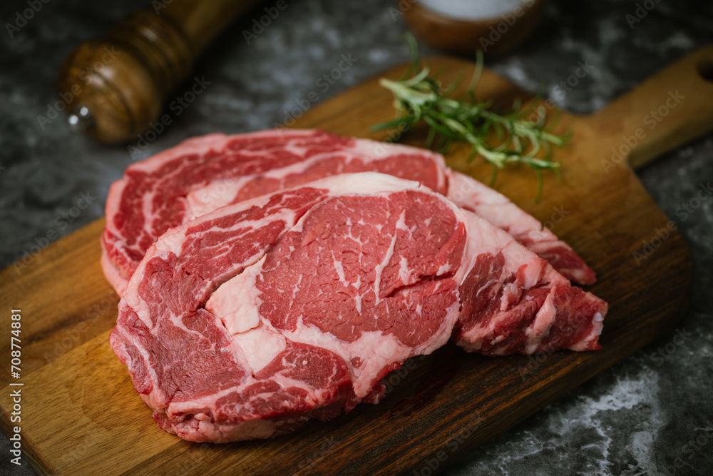 raw ribeye steak meat on black marble background raw ribeye steak meat on black marble background