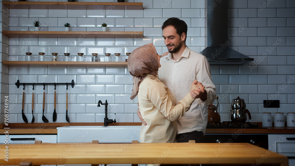 Married happy couple having fun dancing, celebrate their timeless love in the kitchen at home Married happy couple having fun dancing, celebrate their timeless love in the kitchen at home