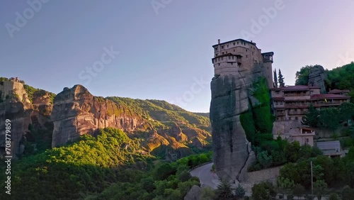 Picturesque nature and architecture of old monastery on mountain cliff top photo