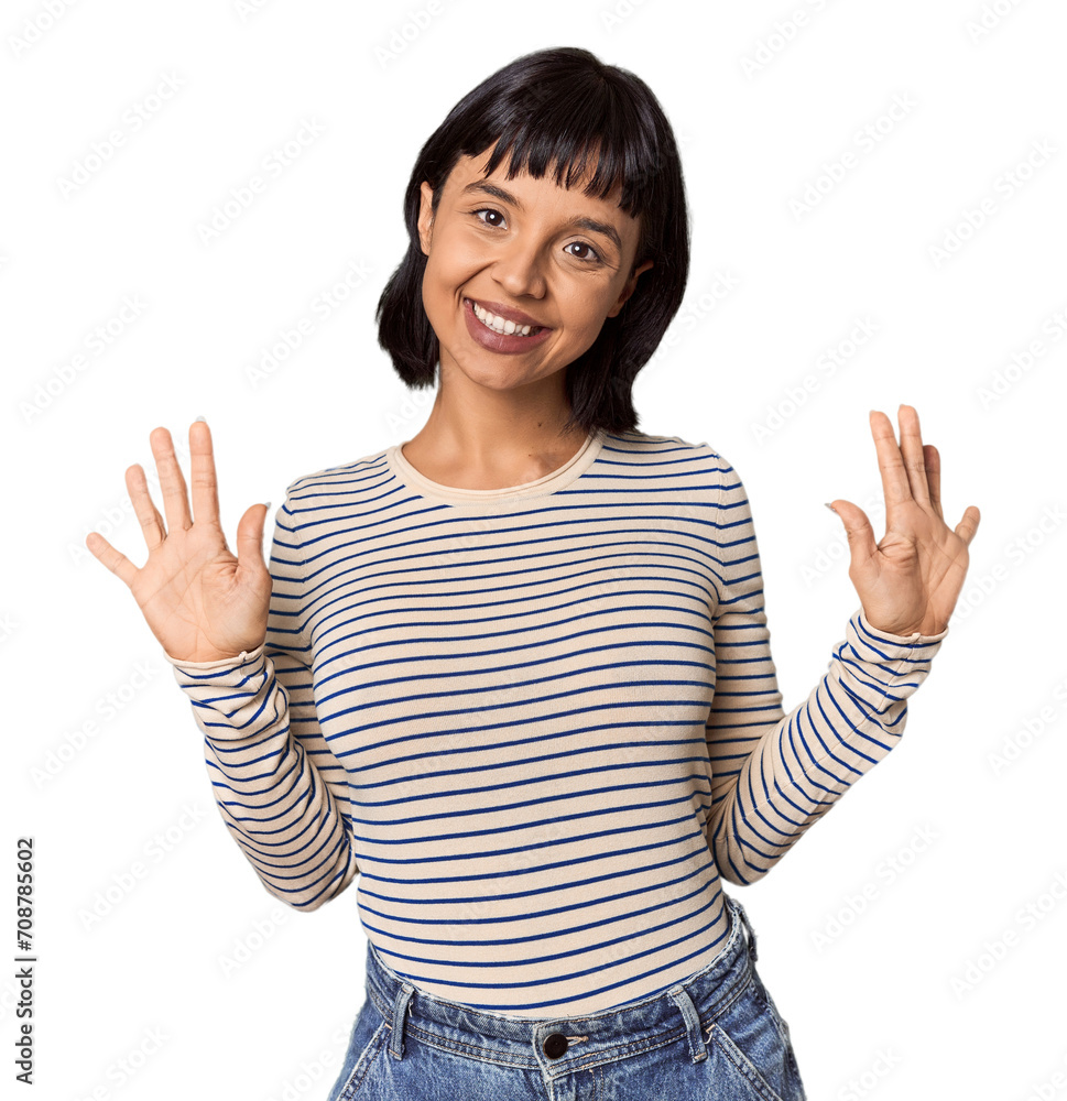 Young Hispanic woman with short black hair in studio showing number ten with hands.