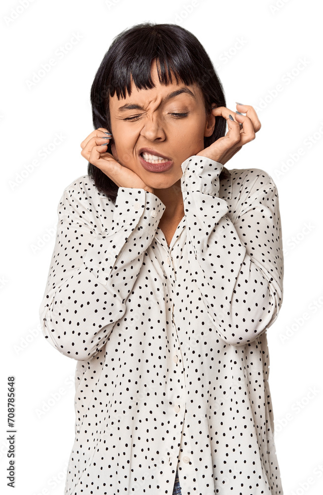 Young Hispanic woman with short black hair in studio covering ears with hands. Young Hispanic woman with short black hair in studio covering ears with hands.