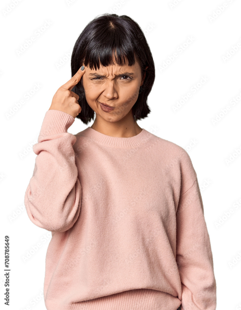 Young Hispanic woman with short black hair in studio pointing temple with finger, thinking, focused on a task. Young Hispanic woman with short black hair in studio pointing temple with finger, thinking, focused on a task.