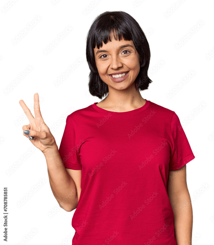 Young Hispanic woman with short black hair in studio showing victory sign and smiling broadly. Young Hispanic woman with short black hair in studio showing victory sign and smiling broadly.