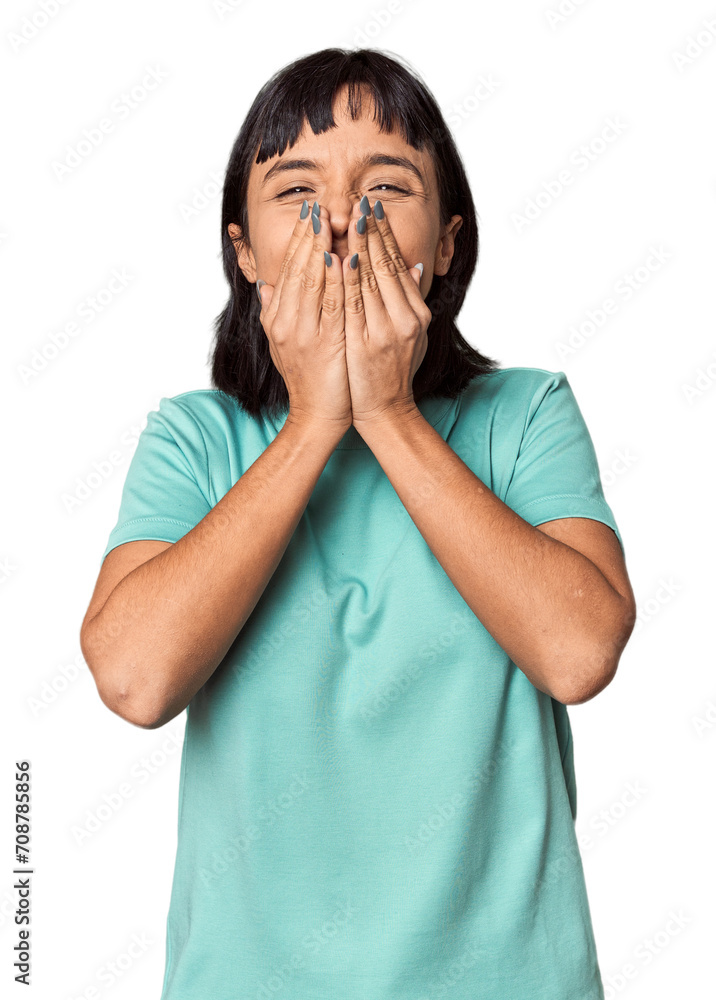 Young Hispanic woman with short black hair in studio laughing about something, covering mouth with hands. Young Hispanic woman with short black hair in studio laughing about something, covering mouth with hands.