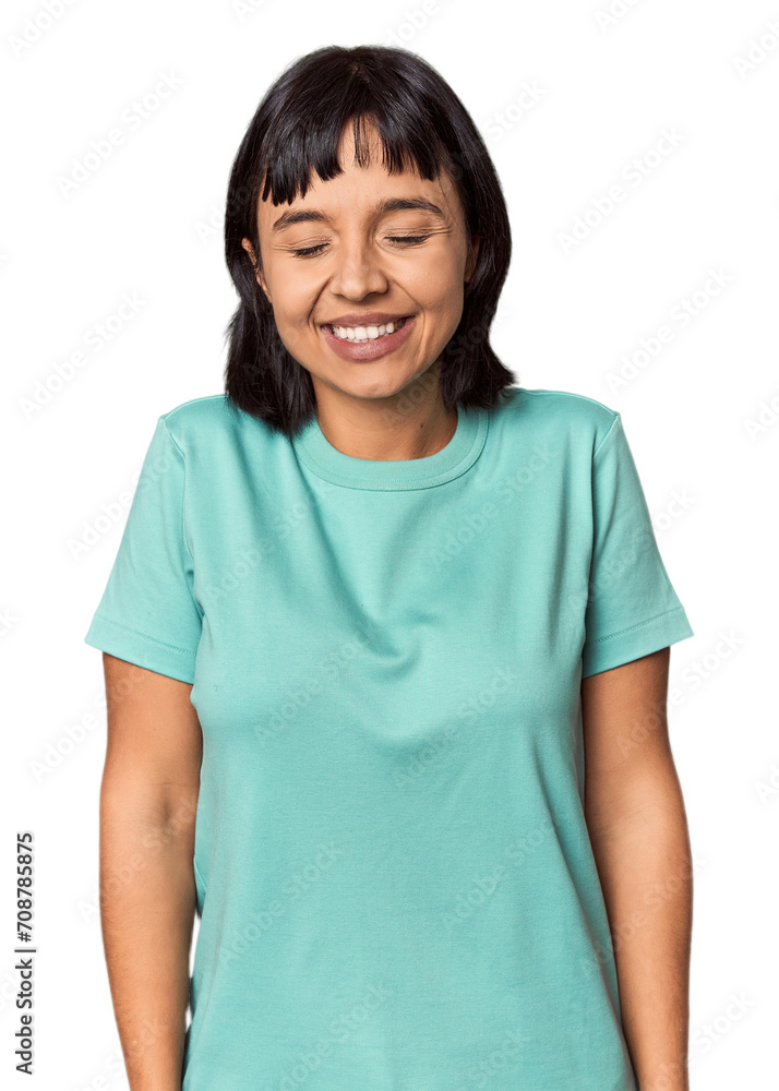 Young Hispanic woman with short black hair in studio laughs and closes eyes, feels relaxed and happy. Young Hispanic woman with short black hair in studio laughs and closes eyes, feels relaxed and happy.